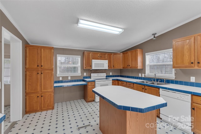 kitchen featuring light floors, light countertops, lofted ceiling, white appliances, and a sink