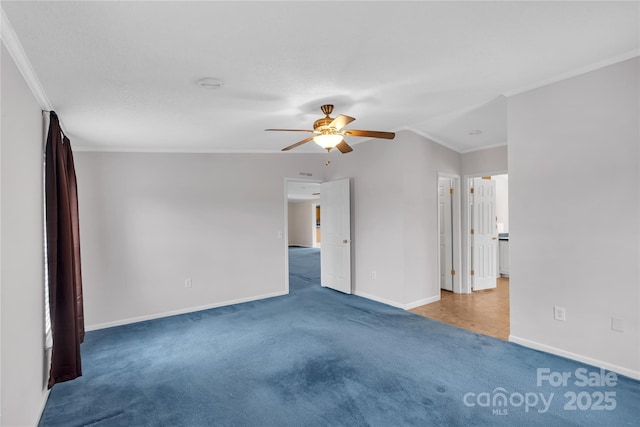 unfurnished bedroom with baseboards, crown molding, carpet, and a ceiling fan