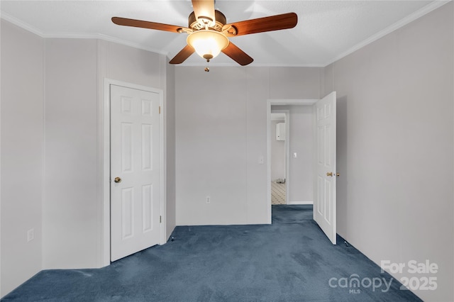 unfurnished bedroom featuring a ceiling fan, carpet, and ornamental molding