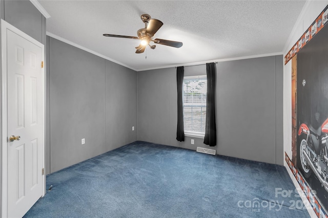 unfurnished bedroom with visible vents, ceiling fan, ornamental molding, carpet flooring, and a textured ceiling