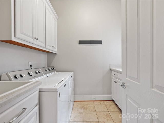 clothes washing area with light tile patterned floors, baseboards, cabinet space, and independent washer and dryer