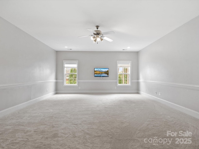 carpeted empty room featuring a wealth of natural light, baseboards, ceiling fan, and recessed lighting