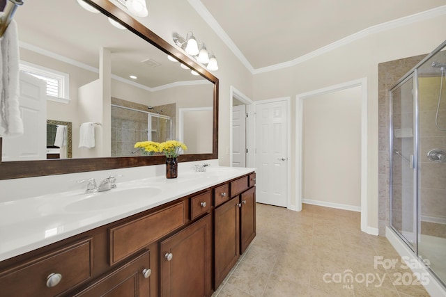 bathroom with a sink, a stall shower, and ornamental molding