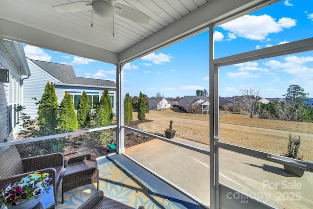 sunroom / solarium with a ceiling fan