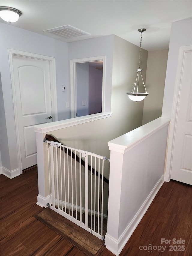 3500 Exbury Gardens Dr, Waxhaw, NC 28173 - corridor with baseboards, an upstairs landing, visible vents, and wood finished floors