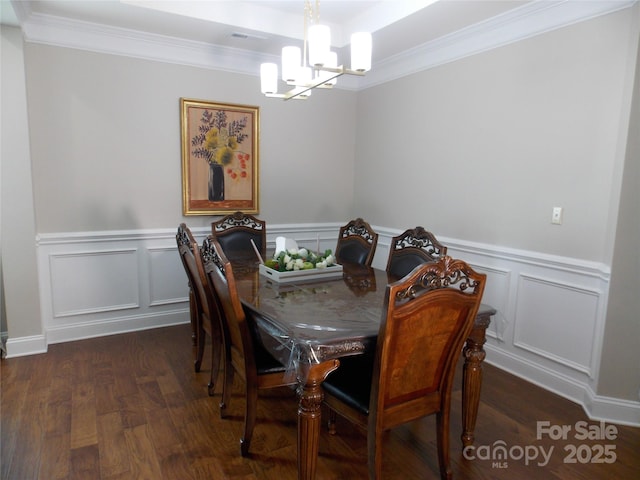 3500 Exbury Gardens Dr, Waxhaw, NC 28173 - dining space featuring crown molding, a decorative wall, wood finished floors, and a notable chandelier