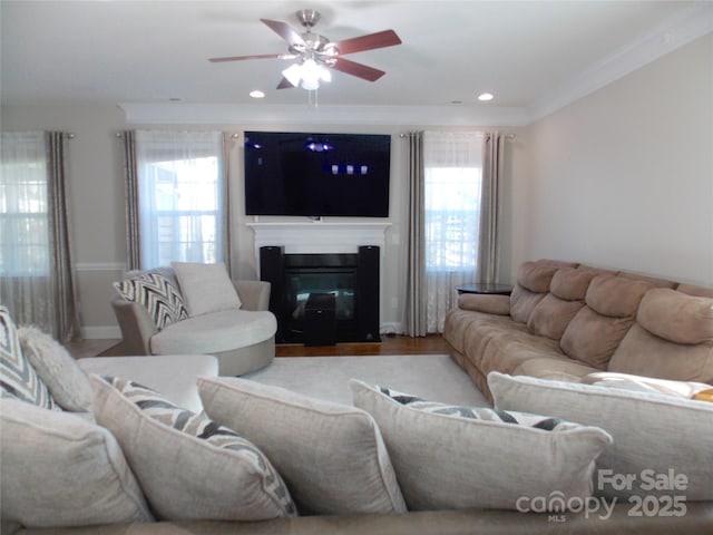 3500 Exbury Gardens Dr, Waxhaw, NC 28173 - living room with a glass covered fireplace, ceiling fan, ornamental molding, and a healthy amount of sunlight