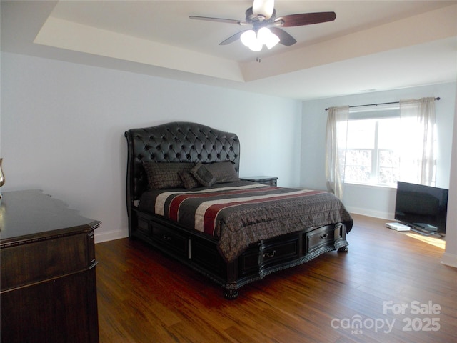 3500 Exbury Gardens Dr, Waxhaw, NC 28173 - bedroom featuring baseboards, a tray ceiling, and wood finished floors