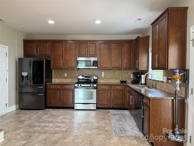 3500 Exbury Gardens Dr, Waxhaw, NC 28173 - kitchen featuring black appliances, a sink, dark stone counters, backsplash, and recessed lighting