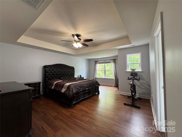 3500 Exbury Gardens Dr, Waxhaw, NC 28173 - bedroom with a raised ceiling, dark wood-style flooring, baseboards, and ceiling fan