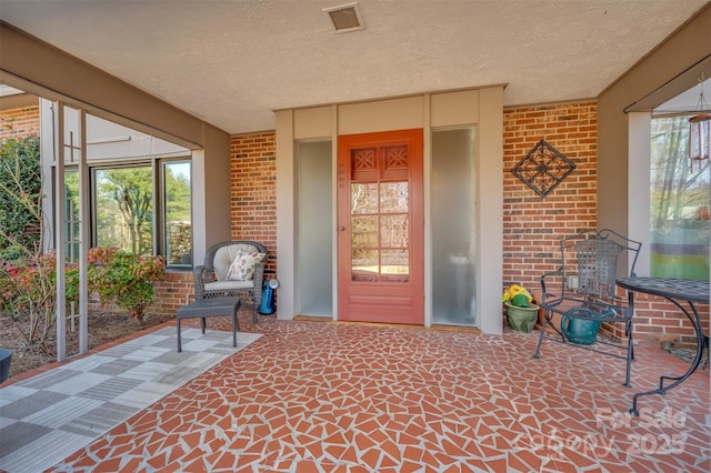 doorway to property with a patio