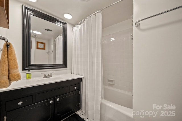 full bathroom with vanity, shower / bath combination with curtain, and visible vents