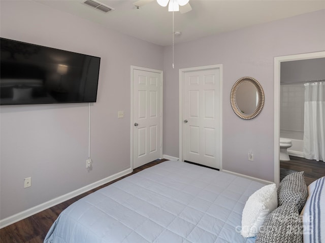 bedroom with a ceiling fan, wood finished floors, visible vents, baseboards, and ensuite bathroom