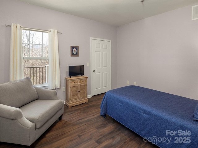 bedroom with visible vents and wood finished floors