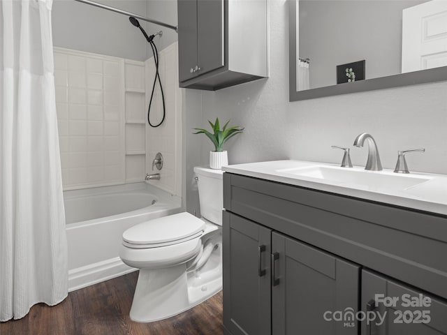 bathroom featuring vanity, toilet, wood finished floors, and shower / bath combo