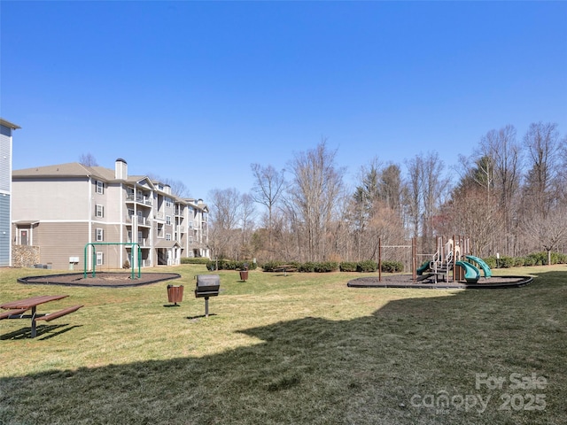 surrounding community featuring a lawn and playground community