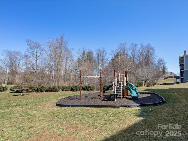 community jungle gym featuring a lawn