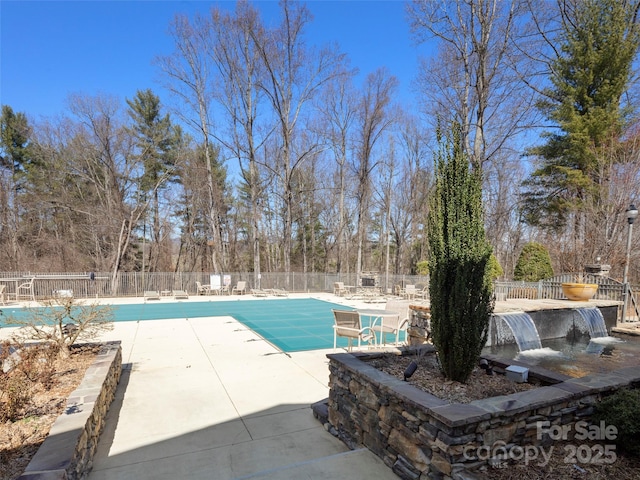 view of pool with a fenced in pool, a patio area, and fence