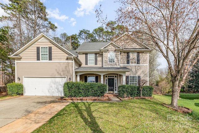 view of front of property featuring driveway, an attached garage, and a front lawn