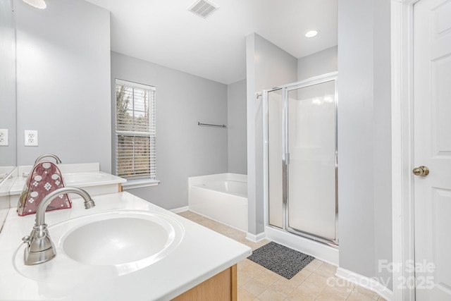 full bathroom with visible vents, double vanity, a sink, a shower stall, and a bath