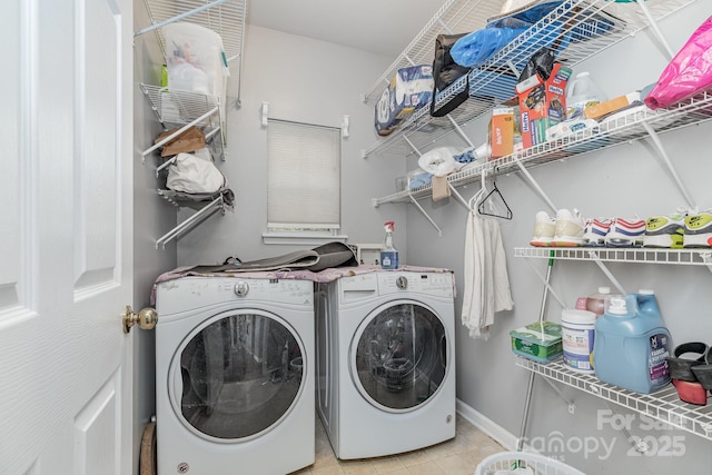 washroom with tile patterned flooring, laundry area, baseboards, and separate washer and dryer