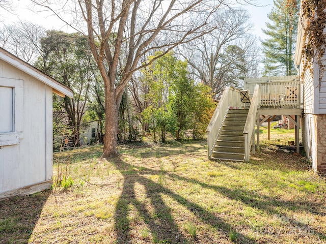 view of yard with a deck and stairway