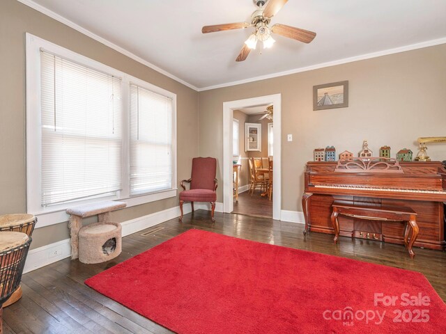 living area featuring hardwood / wood-style flooring, baseboards, and ornamental molding