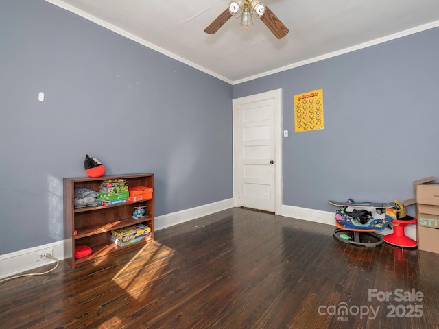 playroom featuring ornamental molding, a ceiling fan, baseboards, and wood finished floors