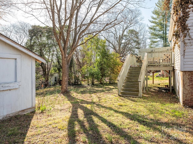 view of yard featuring stairs and a deck