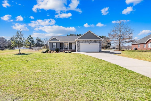 ranch-style house featuring stone siding, a front yard, concrete driveway, and an attached garage