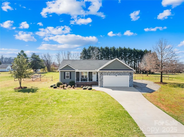 ranch-style home featuring a garage, driveway, a front lawn, and fence