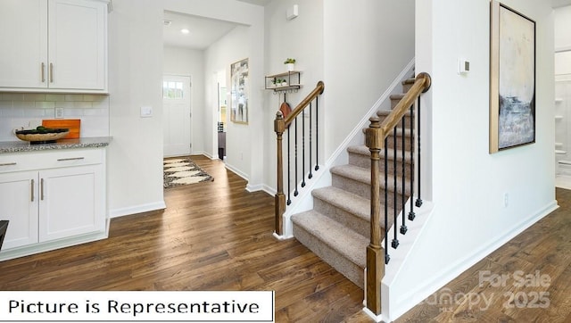 entryway featuring stairway, baseboards, and dark wood-style flooring