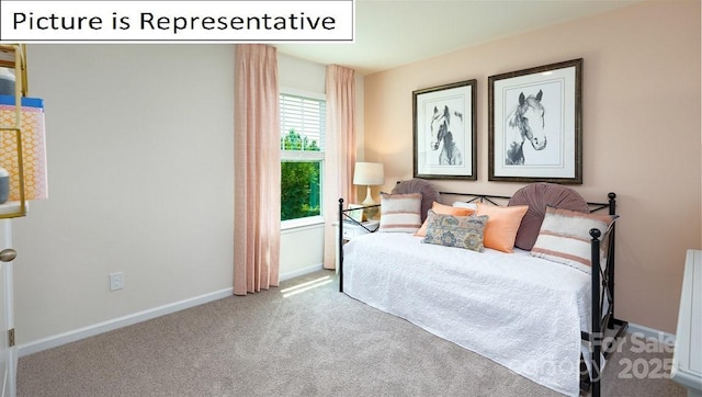 bedroom featuring carpet flooring and baseboards