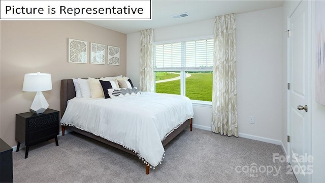 carpeted bedroom featuring visible vents and baseboards