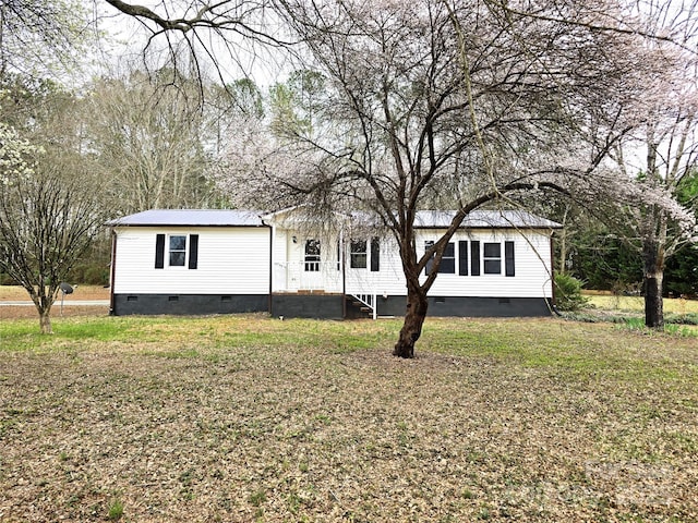 manufactured / mobile home featuring a front yard, metal roof, and crawl space