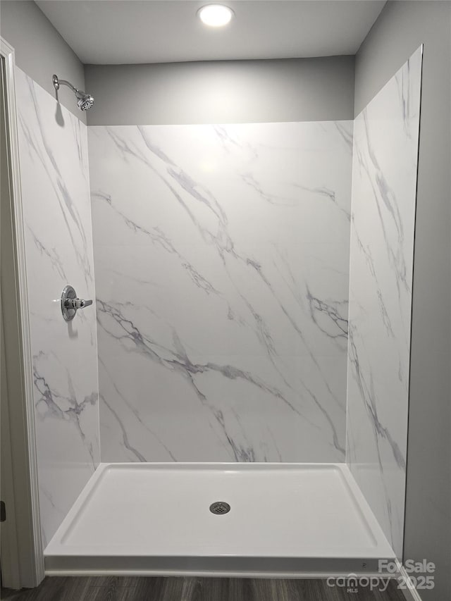 full bath featuring a marble finish shower