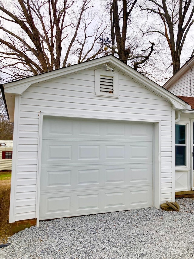 garage with gravel driveway