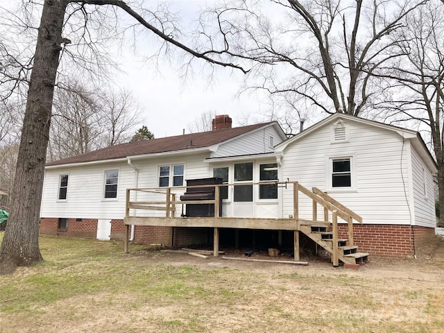 rear view of property featuring a wooden deck, stairs, a lawn, a chimney, and crawl space