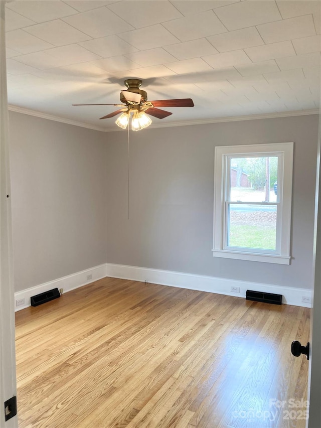 unfurnished room featuring visible vents, baseboards, ornamental molding, wood finished floors, and a ceiling fan