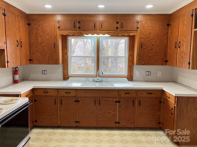 kitchen with brown cabinets, light countertops, and a sink