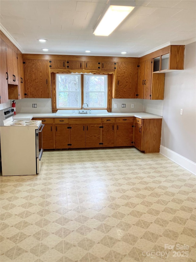 kitchen with light floors, brown cabinets, and electric range oven