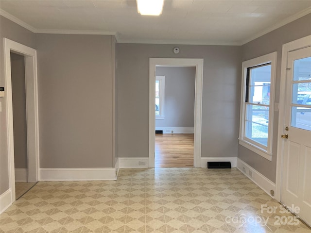 unfurnished room with visible vents, light floors, a healthy amount of sunlight, and ornamental molding