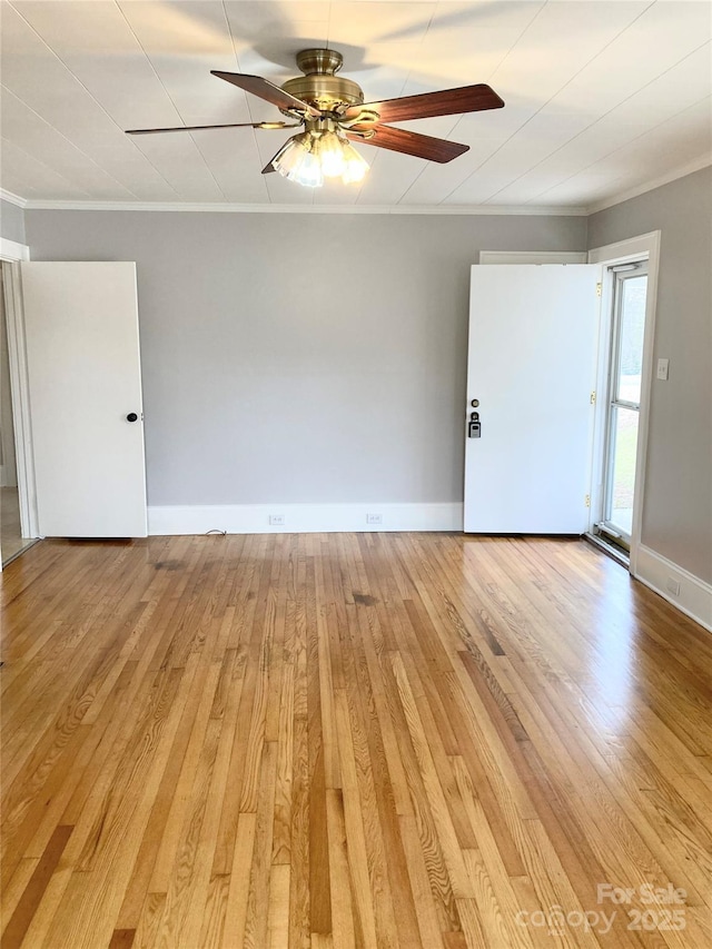 unfurnished room with ceiling fan, baseboards, light wood-style floors, and ornamental molding