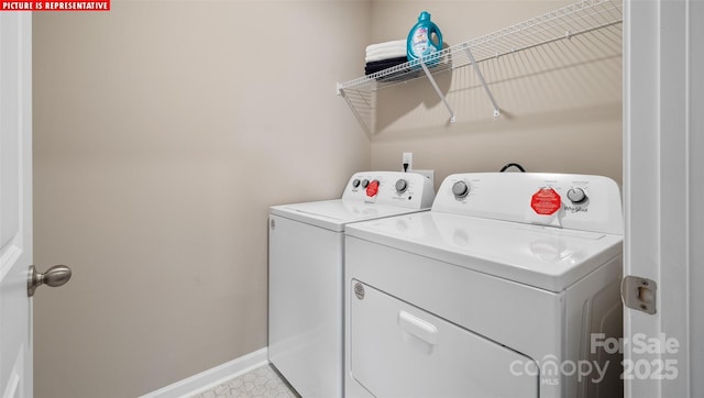 clothes washing area with washer and clothes dryer, laundry area, and baseboards