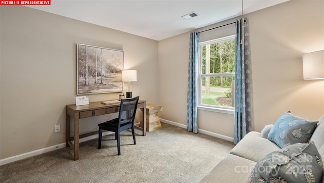 home office with a healthy amount of sunlight, visible vents, and carpet floors