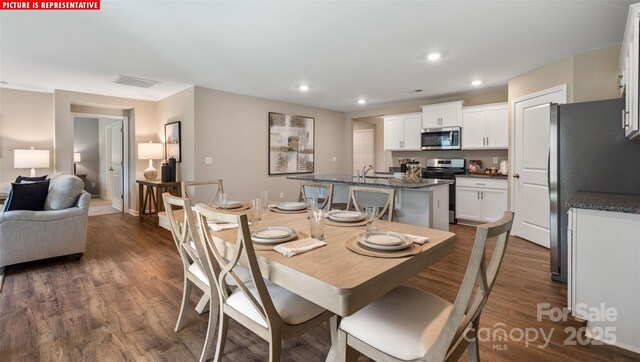 dining area with visible vents, recessed lighting, and dark wood-style flooring