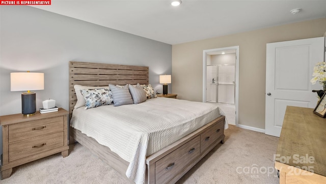 bedroom featuring baseboards, light colored carpet, and ensuite bathroom