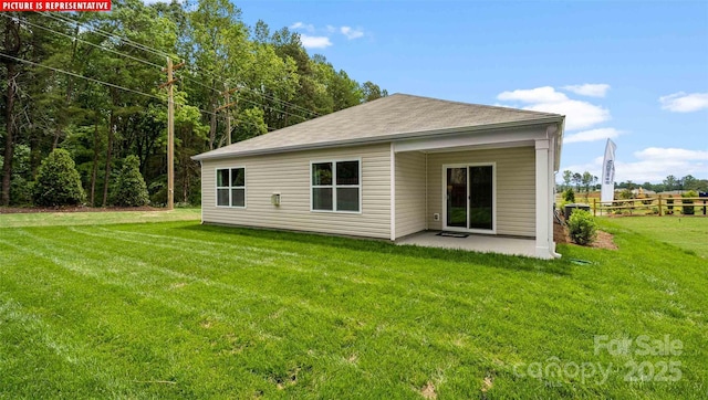 back of property featuring a patio area, a yard, and fence