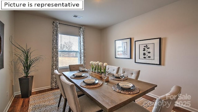 dining area with visible vents, baseboards, and wood finished floors