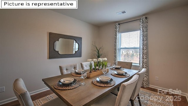 dining room with visible vents, baseboards, and wood finished floors